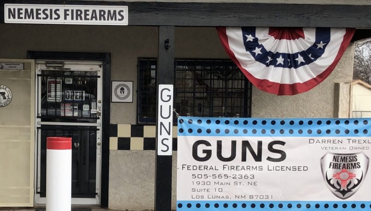 Nemesis Firearms shop with gun signs hanging. 